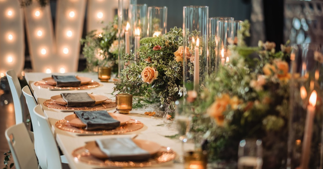 Long, beautifully decorated candlelit table set for wedding reception at Retreat 21 near Columbus, Ohio